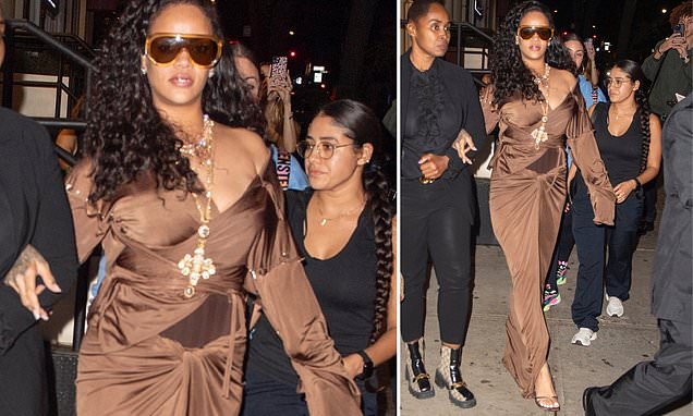 Rihanna turns heads in a silk dress with a VERY racy slit up the front