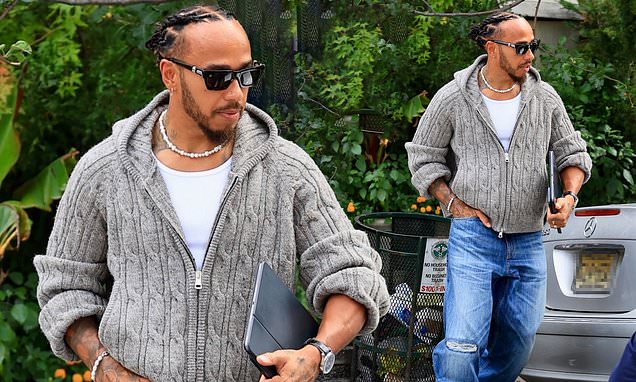 Lewis Hamilton cuts a casual figure in a low-key cardigan and jeans